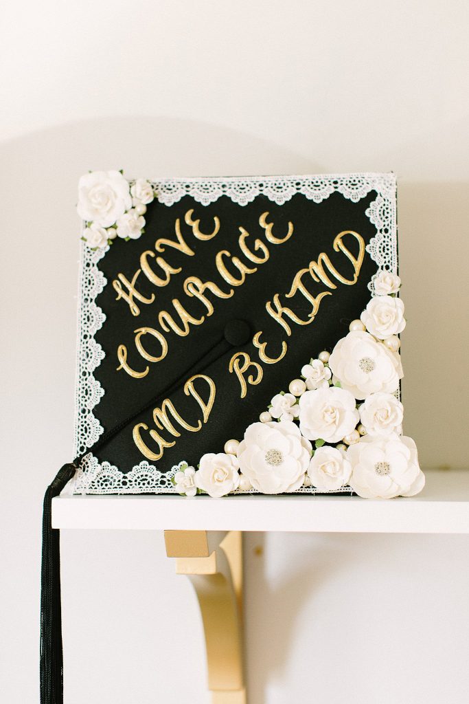 Graduation Cap Inspiration. Black with white flowers. "Have Courage & Be Kind"