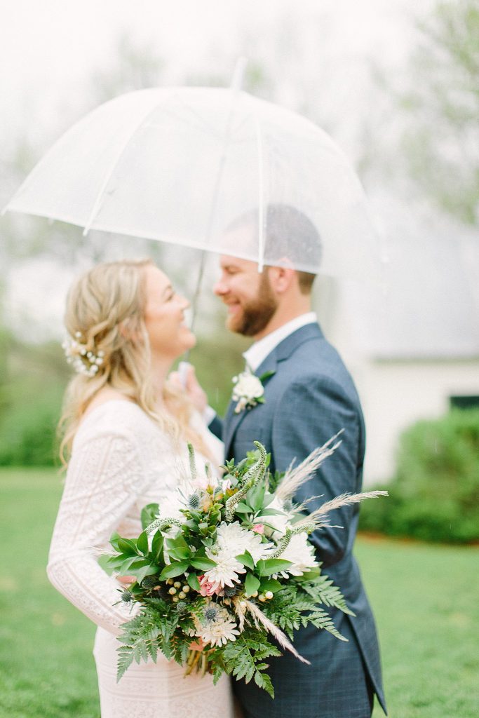 Rainy wedding day in Tennessee. Bride and groom rain photo. 