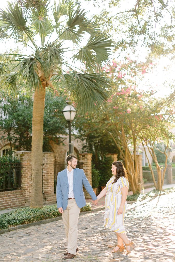 Engagement session in Charleston with palm trees and crepe myrtles. 